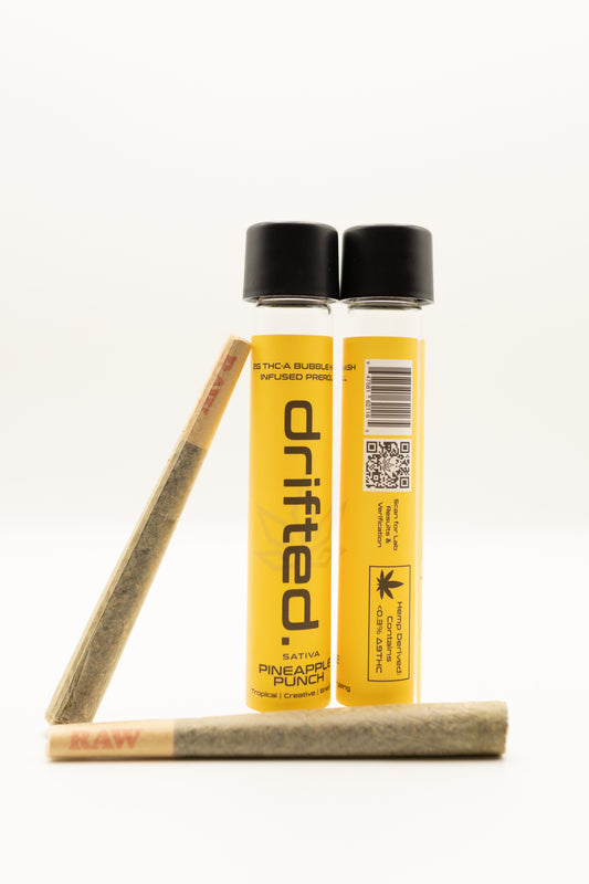 Two Drifted pre-rolled joints with packaging on a white background