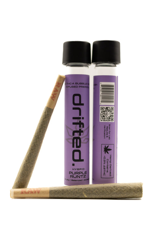 Two Drifted pre-rolled joints with packaging on a white background